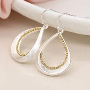 Silver plated brushed twist teardrop earrings with golden bead detail