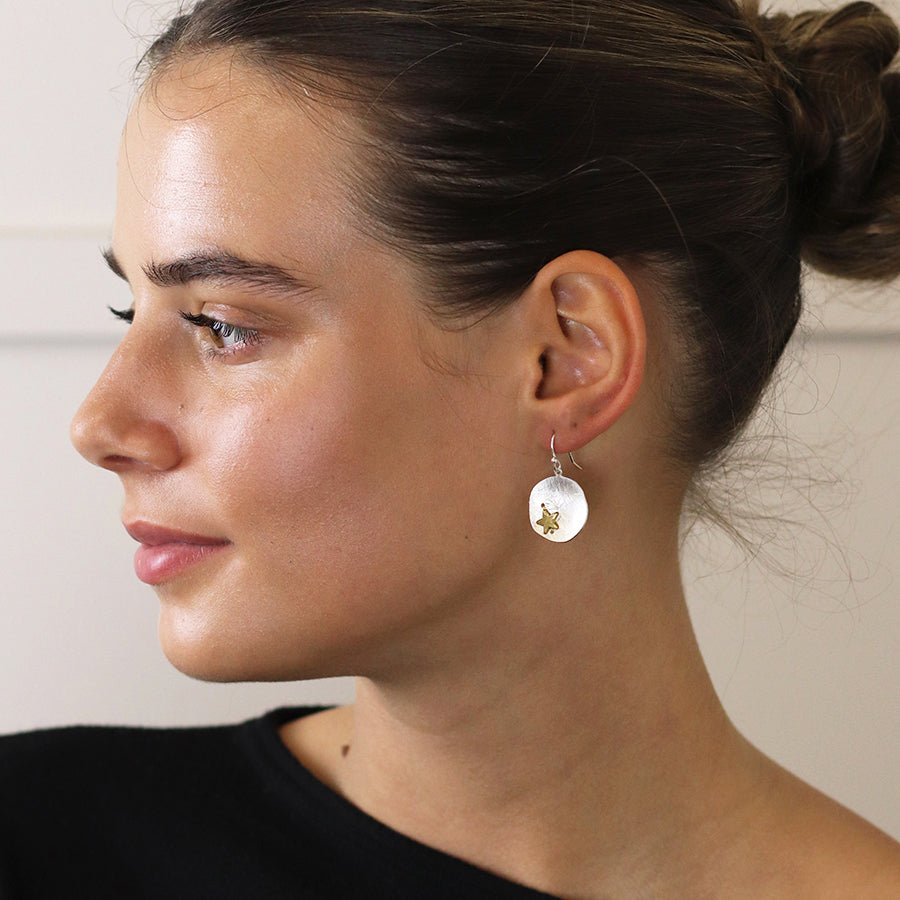 Silver plated scratched finish concave disc earrings with golden star