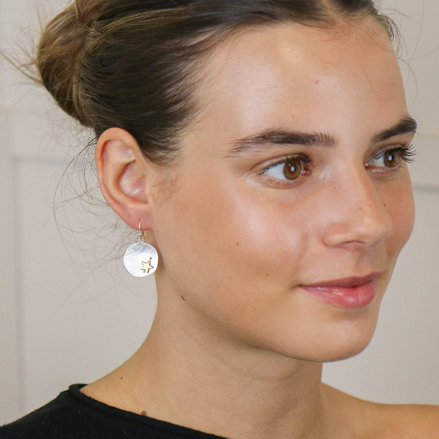 Silver plated scratched finish concave disc earrings with golden star