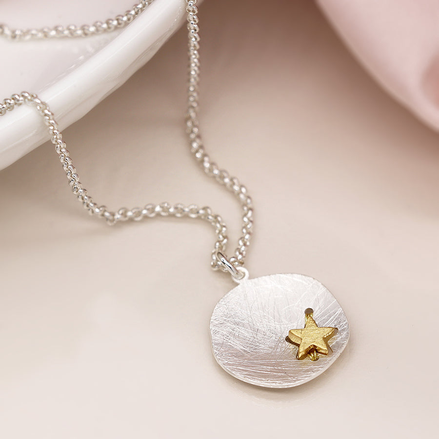 Silver plated scratched finish concave disc necklace with golden star