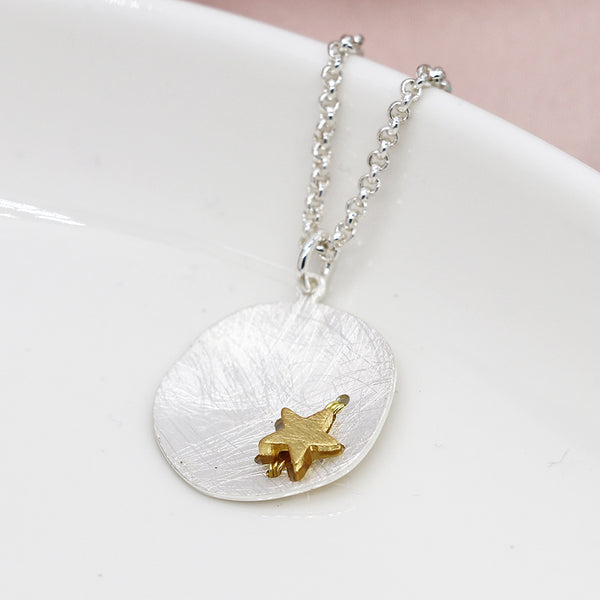 Silver plated scratched finish concave disc necklace with golden star